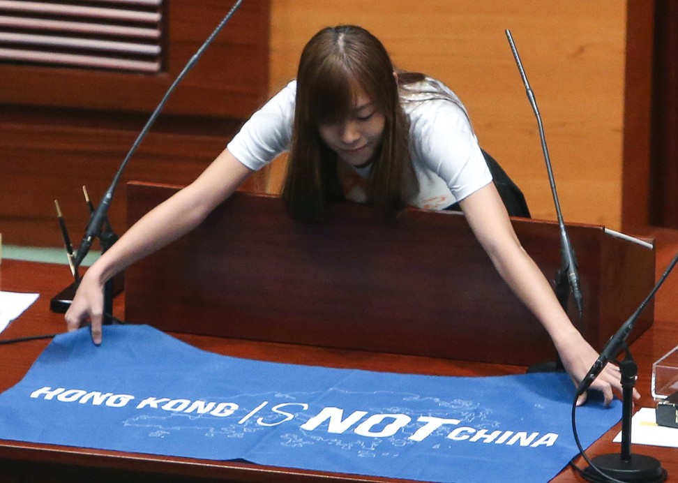 Yau Wai-ching, one of Hong Kong’s six disqualified legislators, spreads out a banner reading “Hong Kong is not China” during the Legislative Council oath-taking session last October 12. Photo: Dickson Lee