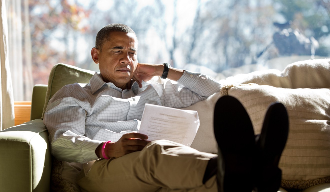 Barack Obama relaxes inside his cabin at Camp David in 2012. Trump told a journalist that the rustic presidential retreat in Maryland’s Catoctin Mountains, would be likable ‘for about 30 minutes’. File photo: AFP