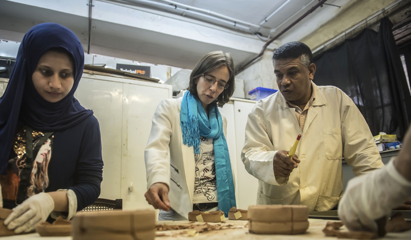 Anita Quiles, a researcher in the French Institute of Eastern Archaeology in Cairo, with local staff at a dating laboratory. Photo: AFP