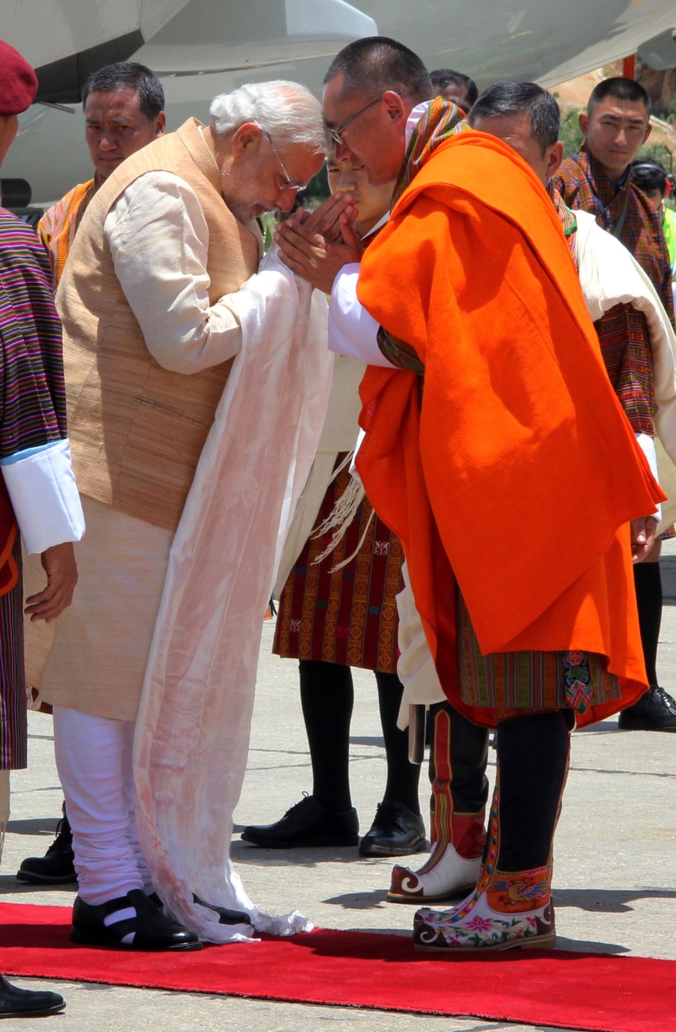 Visiting Indian Prime Minister Narendra Modi is greeted by Bhutanese Prime Minister Tshering Tobgay at Paro Airport on June 15, 2014. India’s control over Bhutan can be seen in three aspects: the economy, military and diplomacy. Photo: AFP