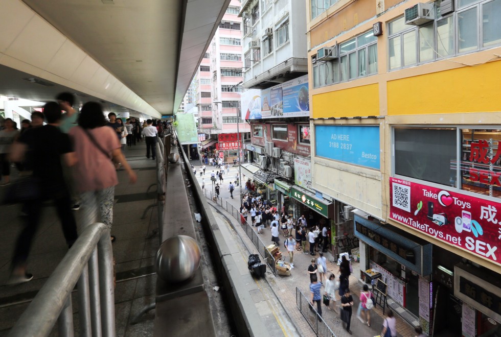 People walk past the display opposite the busy footbridge. Photo: Xiaomei Chen