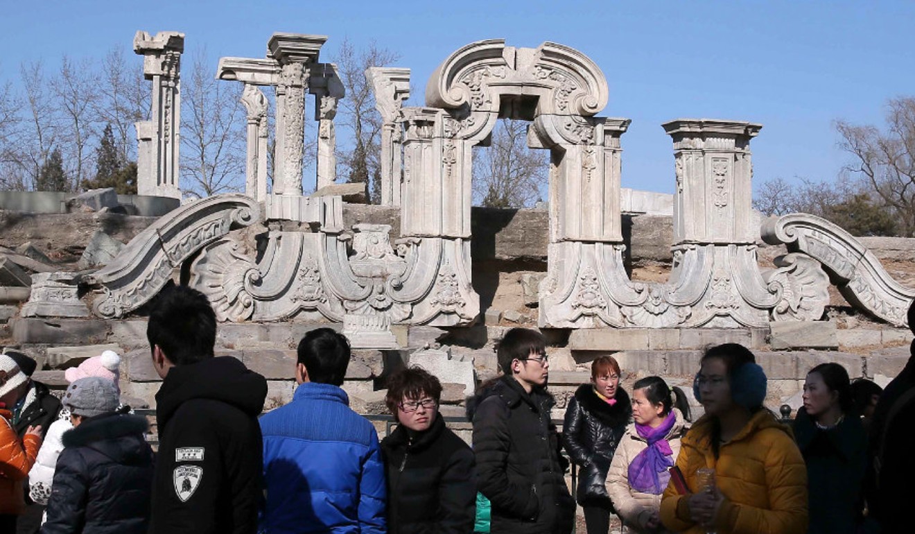 Visitors look at one of the ancient stone relics at the Old Summer Palace in Beijing. Photo: AFP