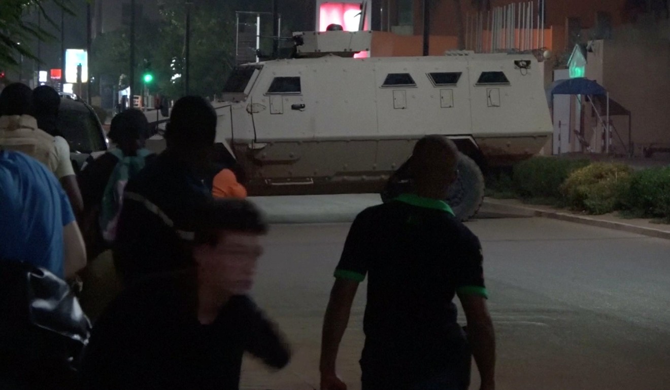 An armoured vehicle opens fire in the direction of a restaurant following an attack by gunmen in Ouagadougou, Burkina Faso, in this still frame taken from video on Sunday. Photo: Reuters