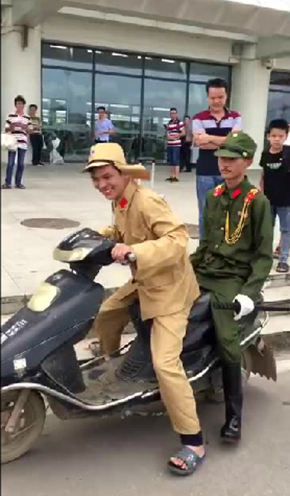 Two men wear Japanese military-style uniforms in Guangxi. Photo: Handout