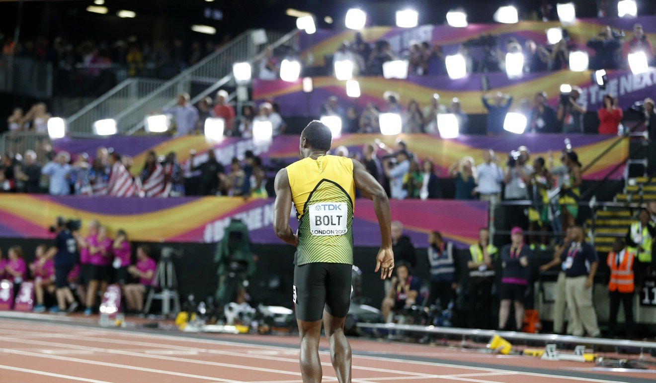 Usain Bolt walks to the finish line after failing to complete the race. Photo: Xinhua