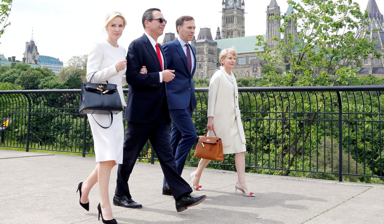 US Secretary of the Treasury Steven Mnuchin and then-fiancee Louise Linton in Ottawa with Canada's Finance Minister Bill Morneau and his wife Nancy McCain. Photo: Reuters