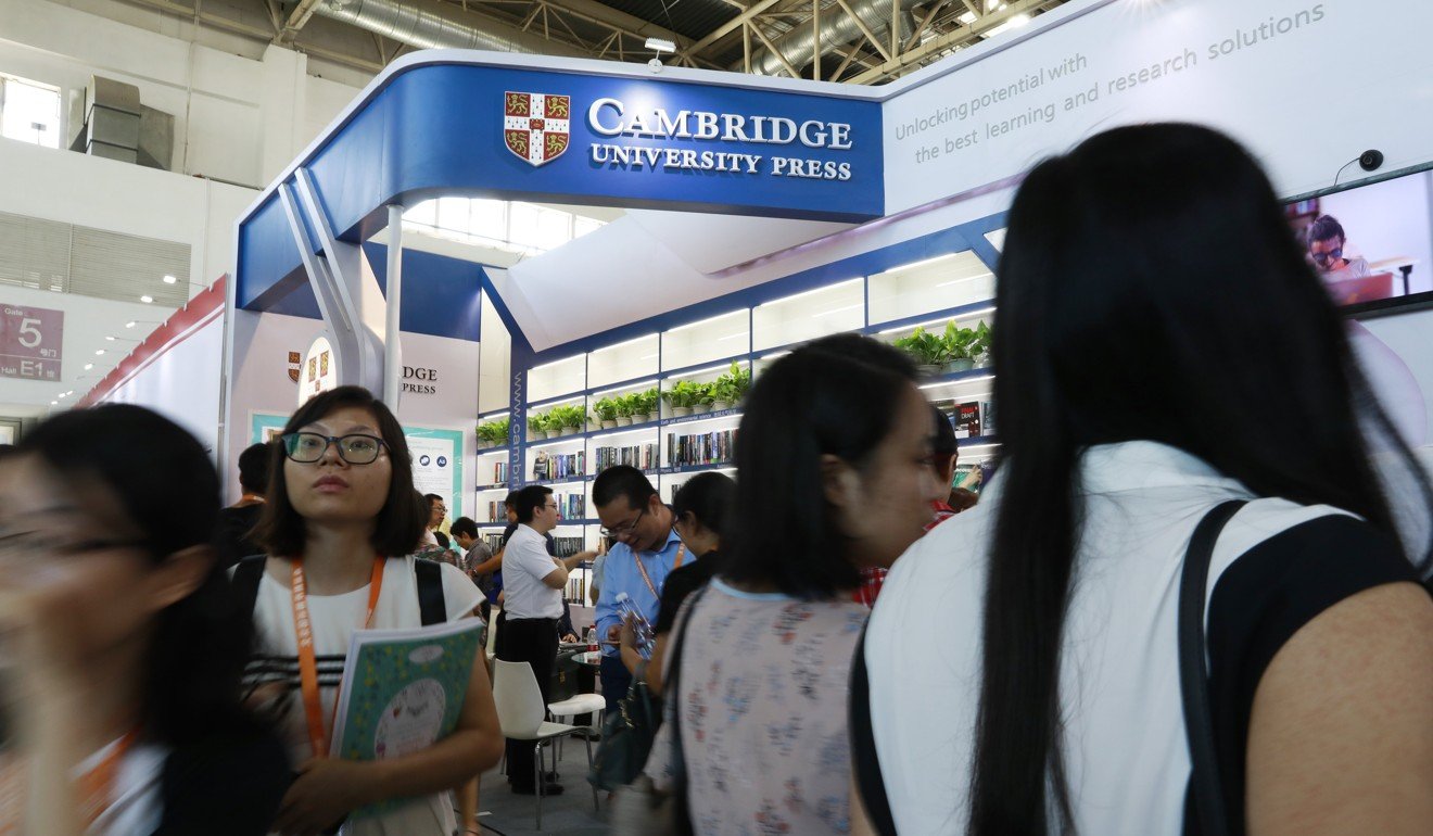 Attendees browse through the collections at Cambridge University Press booth at the 24th Beijing International Book Fair in Beijing. Photo: EPA