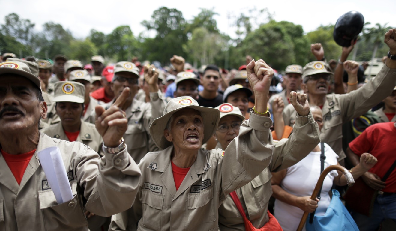 Militia members shout slogans during a speech by the commander of the Venezuelan Bolivarian Militia in Caracas after President Nicolas Maduro ordered military exercises in response to President Donald Trump's warning of possible military action. Photo: AP