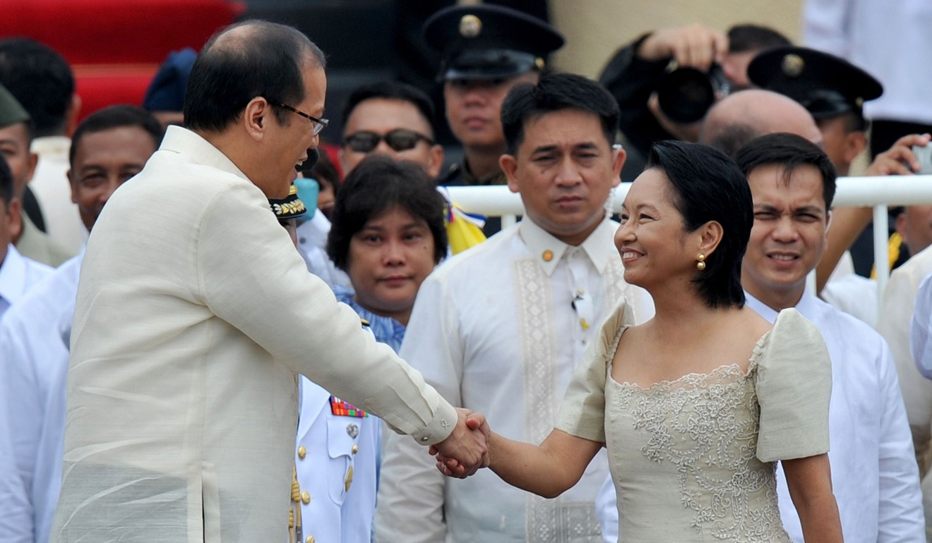 Philippine President Benigno Aquino, left, sees off his predecessor, Gloria Arroyo, right, at the Luneta Grandstand in Manila in 2010, during turnover ceremonies ahead of his oath taking as the country's 15th president. Aquino was sworn in as president of the Philippines with a vow to lift his nation out of poverty and wipe out crippling corruption that he said thrived under his predecessor. Photo: AFP