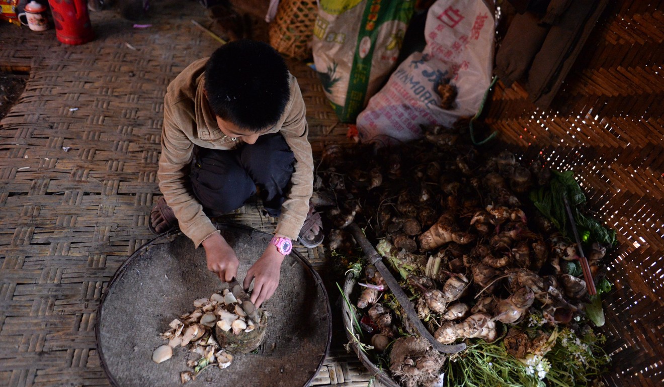 A teenager prepares food in the western Yunnan highlands, one of the poorest areas of the country. Photo: Xinhua