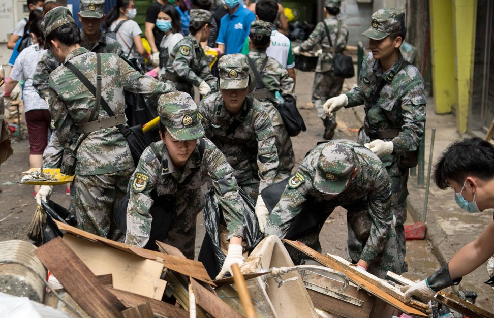 Soldiers help with the relief work after Typhoon Hato ripped through Macau. Photo: Cheong Kam Ka