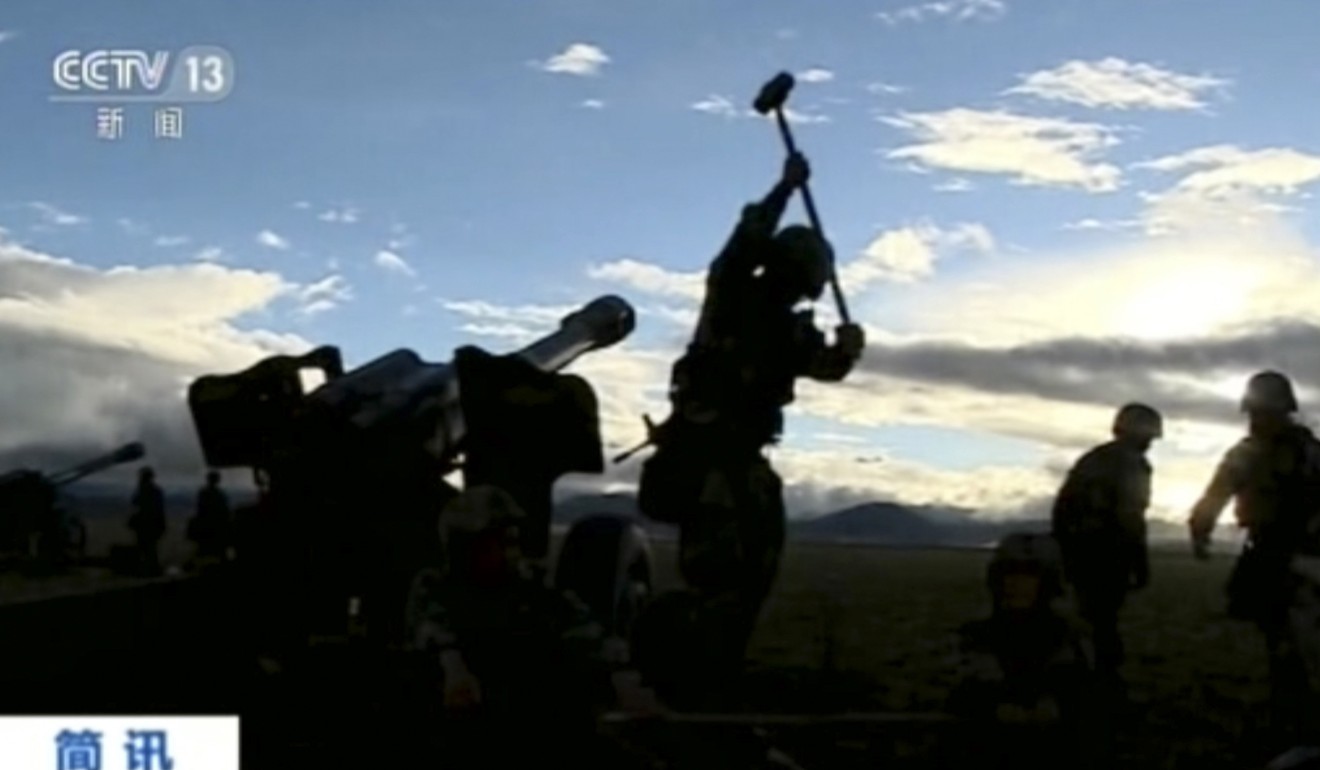 Chinese soldiers prepare artillery guns during a live-fire drill in the Tibet Autonomous Region bordering India, in an image from video footage run by China’s CCTV on August 4. The drill came as Beijing intensified its warnings to Indian troops to withdraw from the Doklam tri-junction with Bhutan. Photo: AP