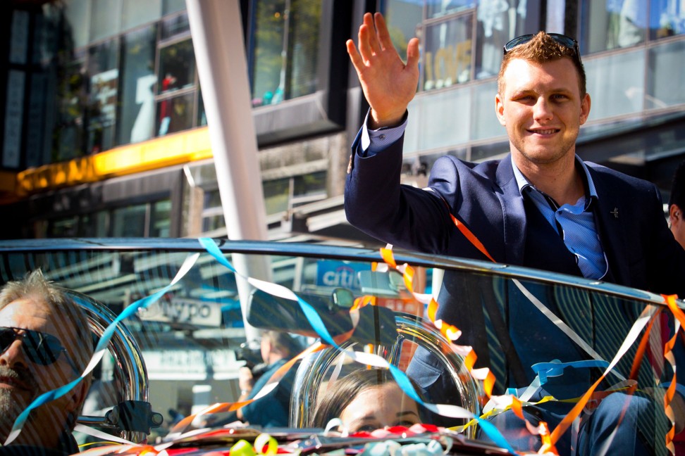World Boxing Organisation welterweight title holder Jeff Horn waves during his post-fight victory parade in Brisbane. Photo: AFP