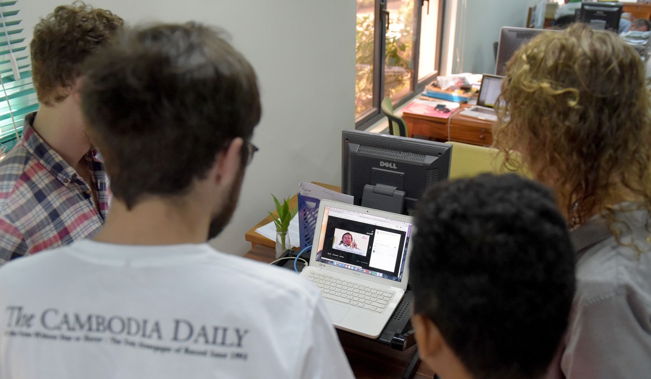 Reporters of the English-laguage newspaper Cambodia Daily watch a video clip featuring Cambodian opposition leader Kem Sokha at their newsroom in Phnom Penh. Photo: AFP