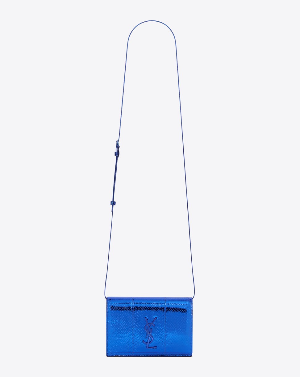 This bag made from Ayers snakeskin comes in a vibrant metallic blue. It also features a blue YSL metal motif.