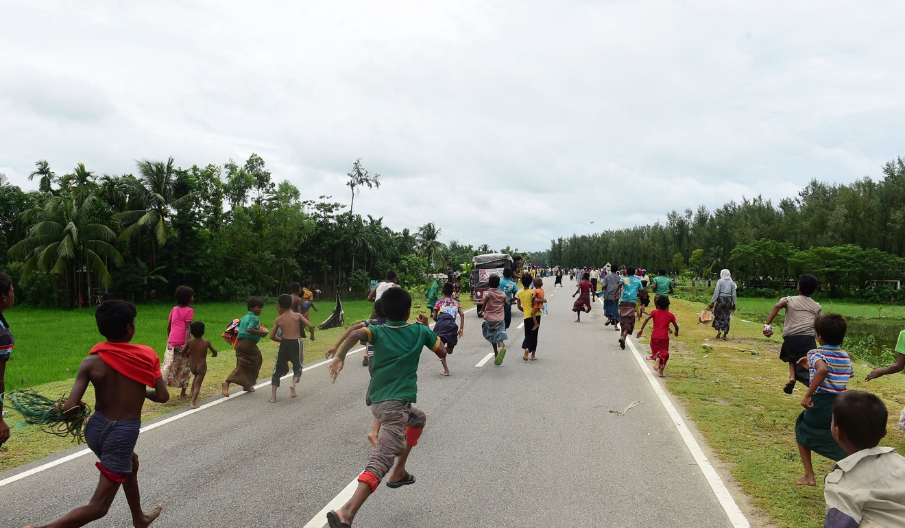 Rohingya Muslim refugee children follow a vehicle with relief supplies near the Bangladeshi town of Teknaf. Photo: AFP