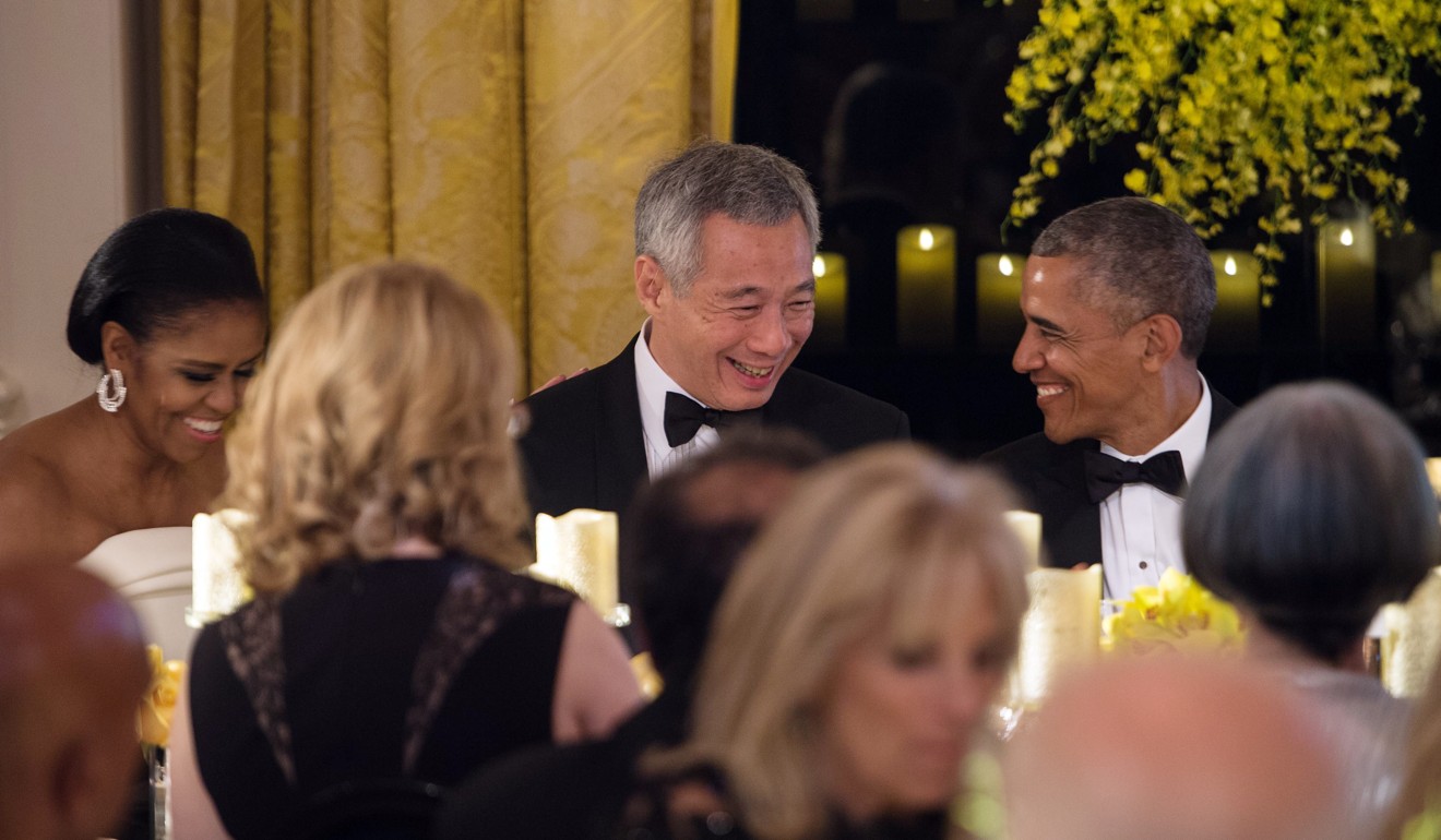 Singapore’s Prime Minister Lee Hsien Loong chats with US President Barack Obama during a state dinner in his honour at the White House. Photo: AFP