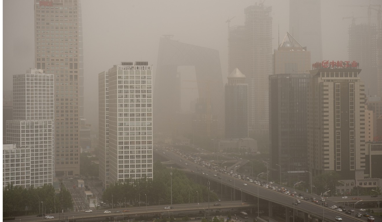 A dust storm shrouds Beijing’s central business district in May. Photo: AFP