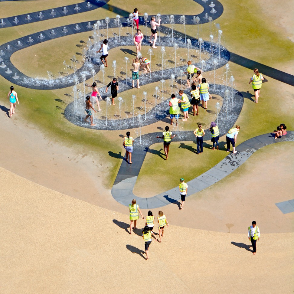 Children play outdoors in water fountain jets on a school trip to London’s Olympic park. Free activities like this will keep kids amused and help stretch your budget. Photo: Alamy