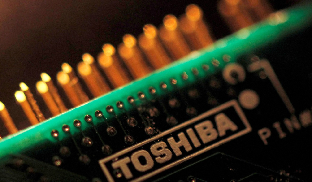A logo of Toshiba is seen on a printed circuit board. Photo: Reuters