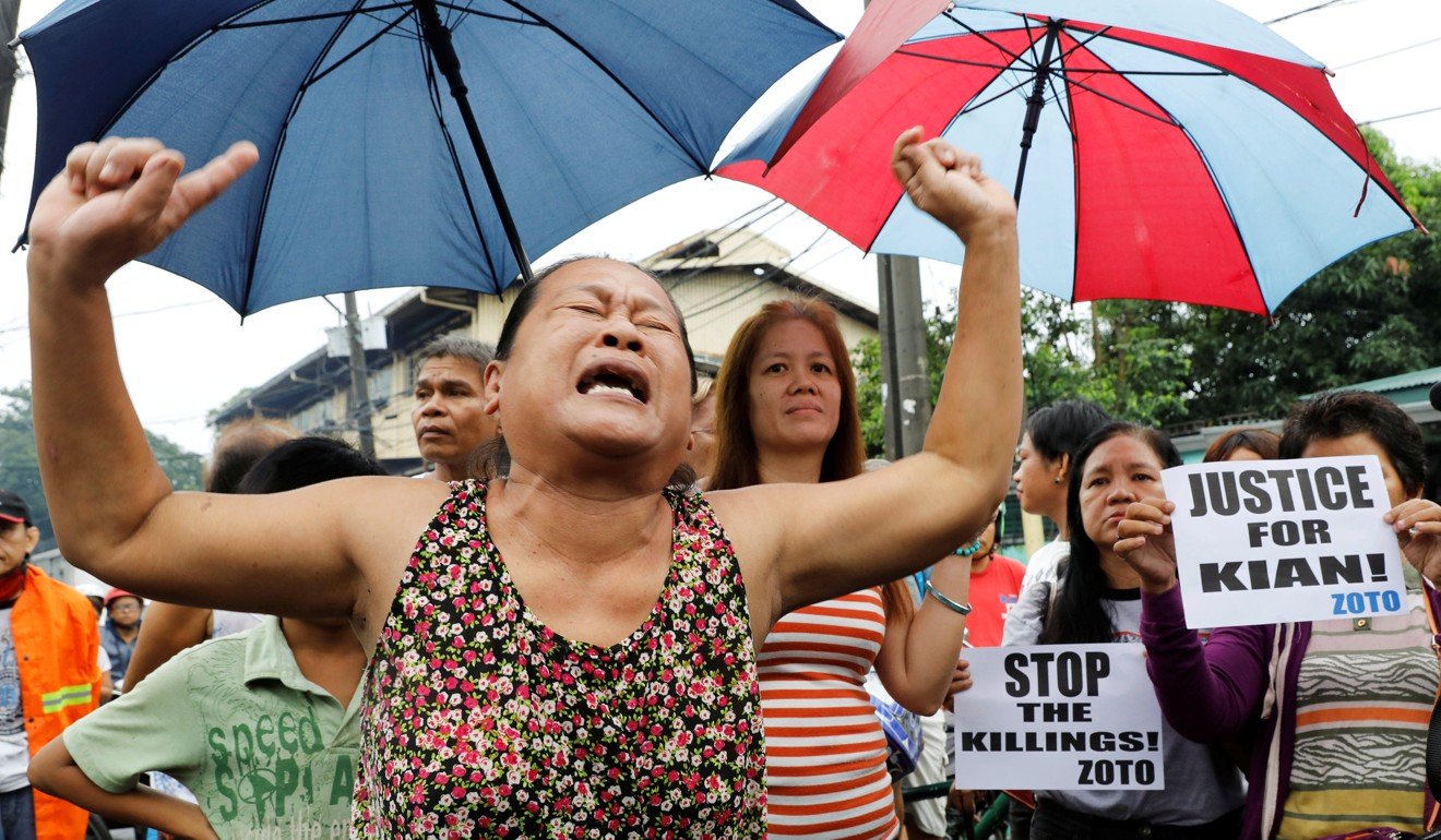 A woman cries during the funeral march of Kian Delos Santos in Manila. Her son was also shot in a drug-related killing - part of President Rodrigo Duterte’s drug war. Photo: Reuters