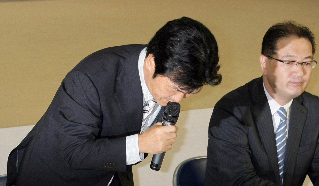 Japanese comedian and TV host Shinsuke Shimada bows as he announces his retirement from the entertainment business. Shimada quit show business after being found to have a cozy relationship with a yakuza gangster. Photo: AFP