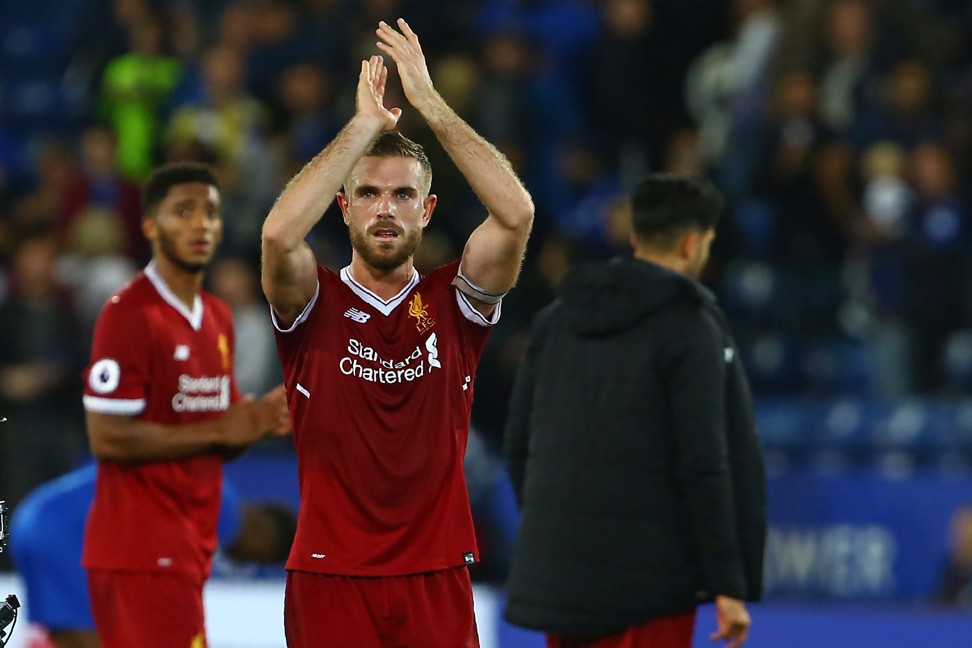 Jordan Henderson applauds supporters on the pitch. Photo: AFP