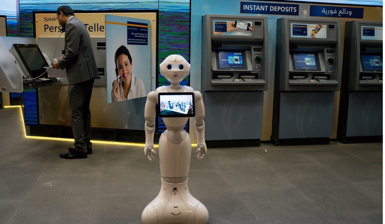 An information robot stands ready to assist customers in front of ATMs at an Emirates NBD bank branch in the Dubai Mall, in the United Arab Emirates, on September 12. Photo: Bloomberg