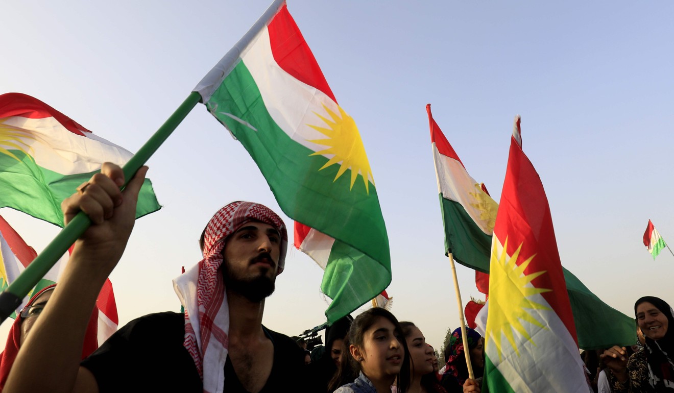 Syrian Kurds wave the Kurdish flag during a gathering in support of the independence referendum in Iraq's autonomous northern Kurdish region. Photo: AFP