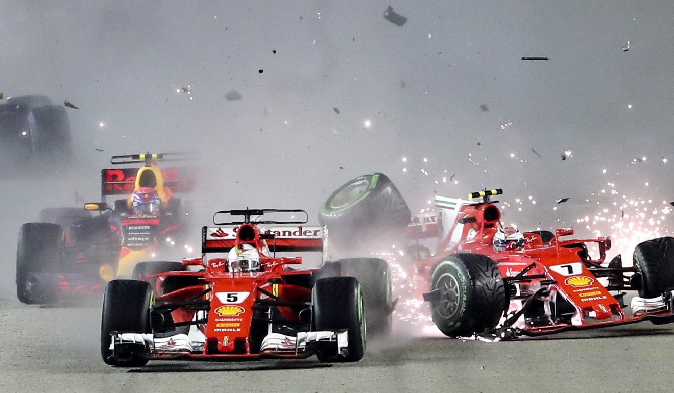 Sebastian Vettel (L) and teammate Kimi Raikkonen collide at the start of the Singapore Formula One Grand Prix. Photo: EPA