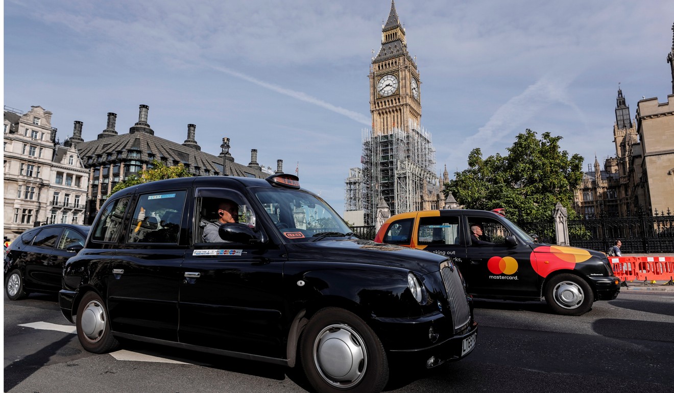 Black taxis pass the Houses of Parliament in London, Britain. Barring a reversal in an appeal court, Uber will soon be banned in the city. Photo: Reuters