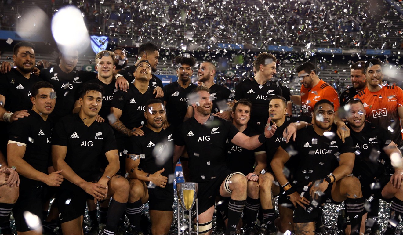 New Zealand players celebrate with the trophy after winning the Rugby Championship. Photo: Reuters