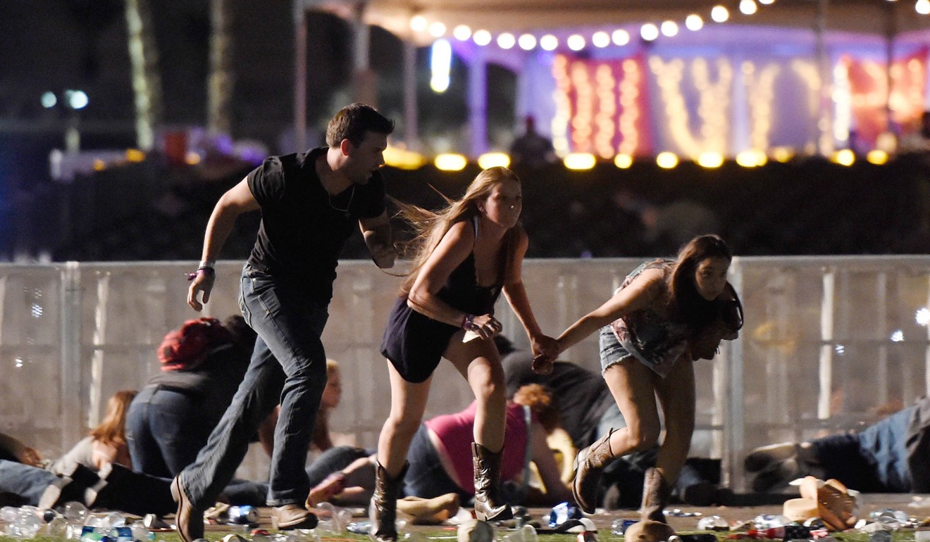 People run from the Route 91 Harvest country music festival after gunfire erupted. Photo: AFP