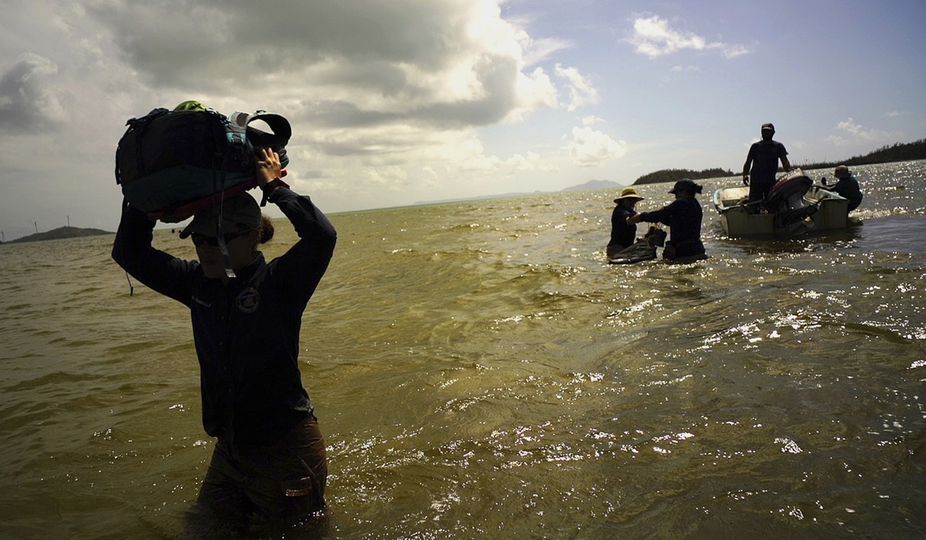 Scientists return to land from Cayo Santiago, known as Monkey Island, in Puerto Rico. Photo; AP
