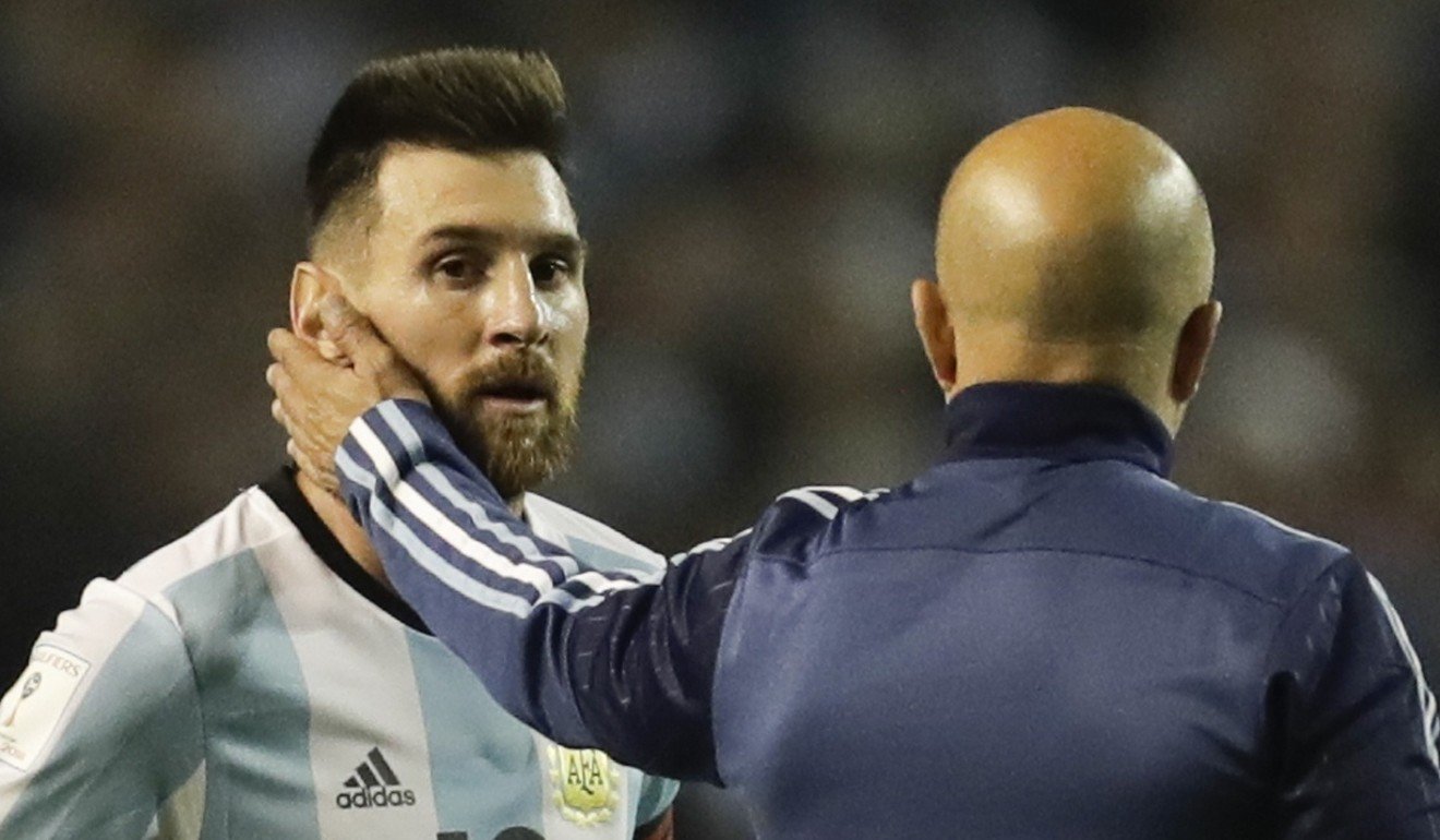Lionel Messi is comforted by Argentina coach Jorge Sampaoli after the draw at home to Peru. Photo: AP