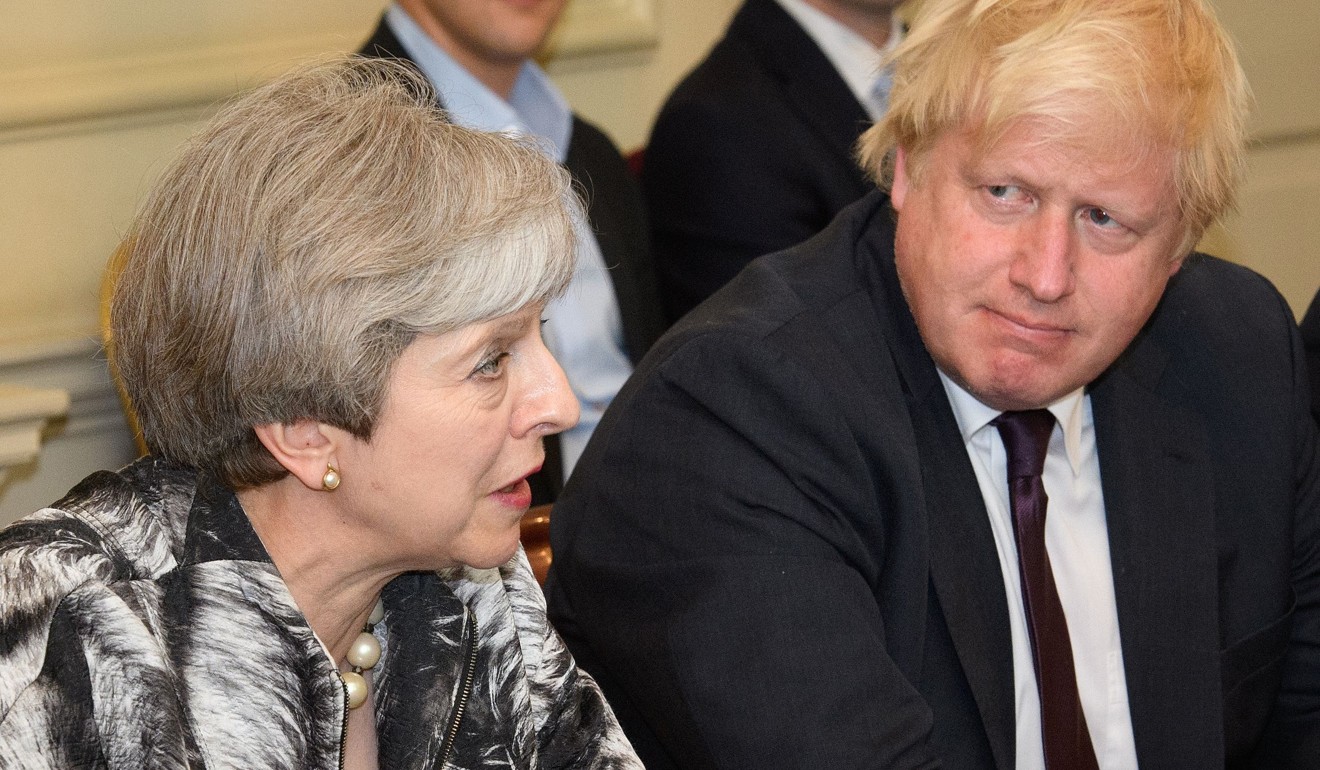 May with Johnson during her first cabinet meeting. Photo: AFP