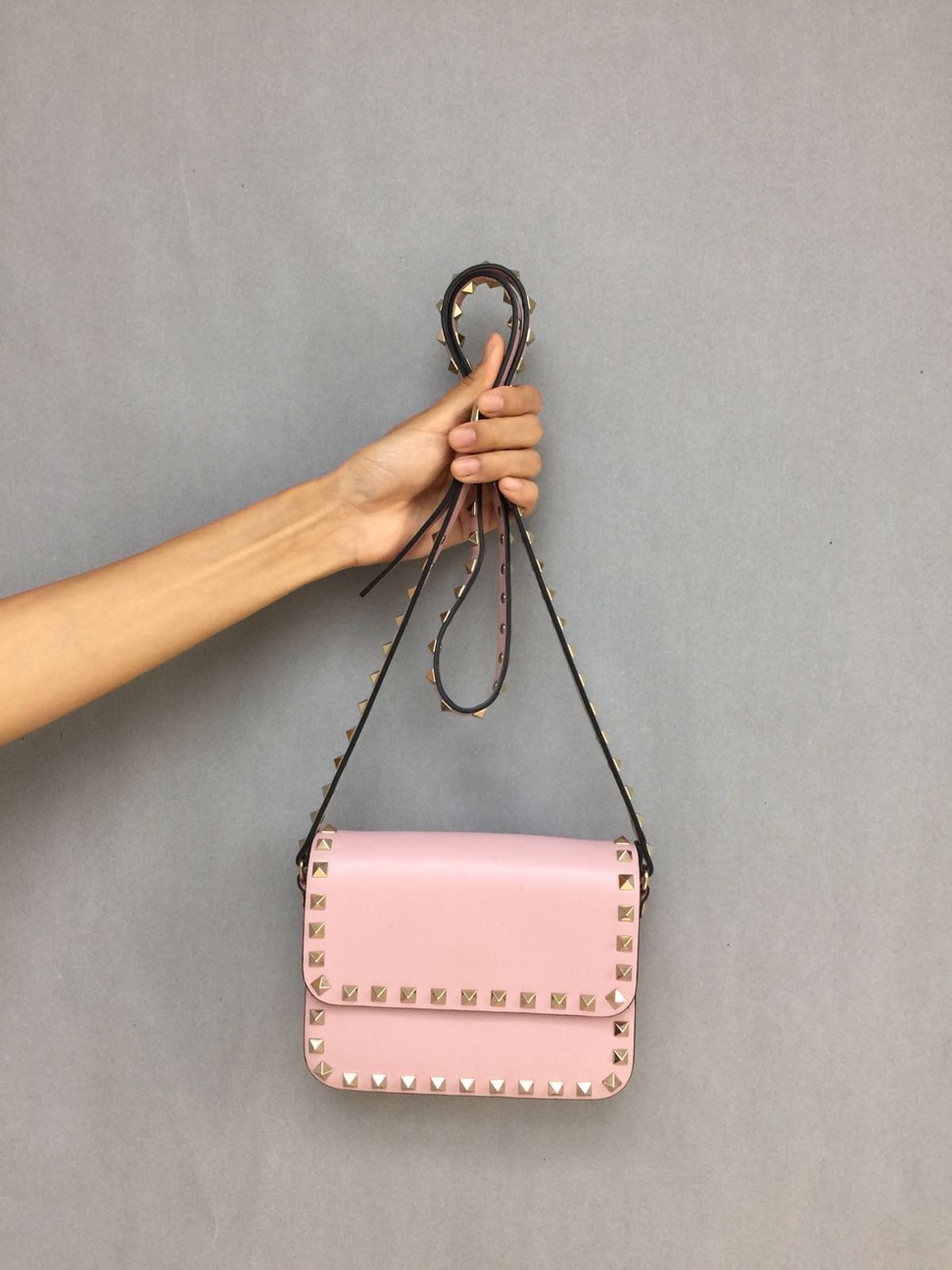 Louise Wong donates a Valentino rock-studded shoulder bag.