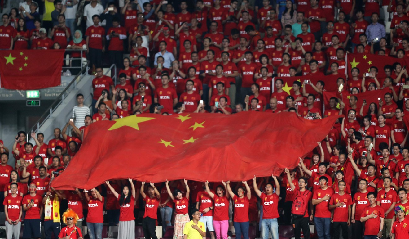 Chinese football fans hold up their national flag before the start of the Fifa World Cup 2018 qualification match against Qatar in September. Patience on the mainland towards the Hong Kong protests against the national anthem are believed to be wearing thin. Photo: AFP