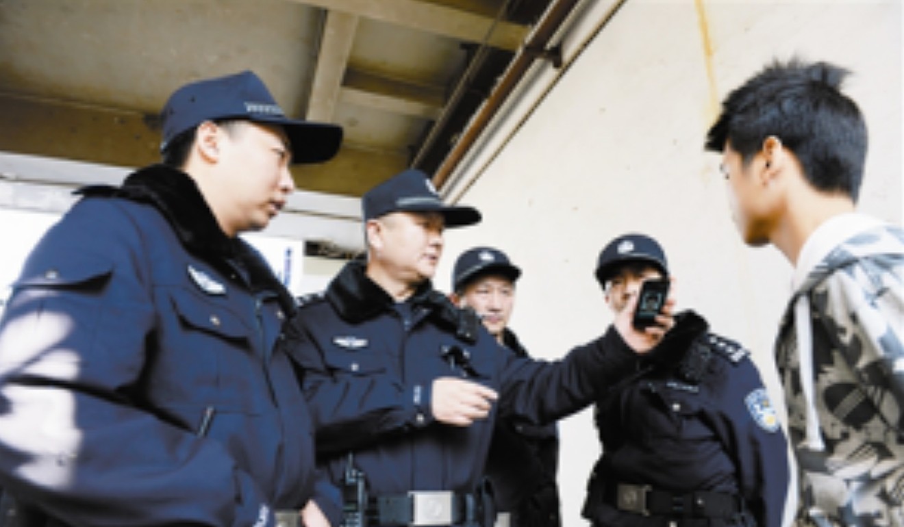 Police use hand-held devices to connect to a facial recognition system. Photo: Handout