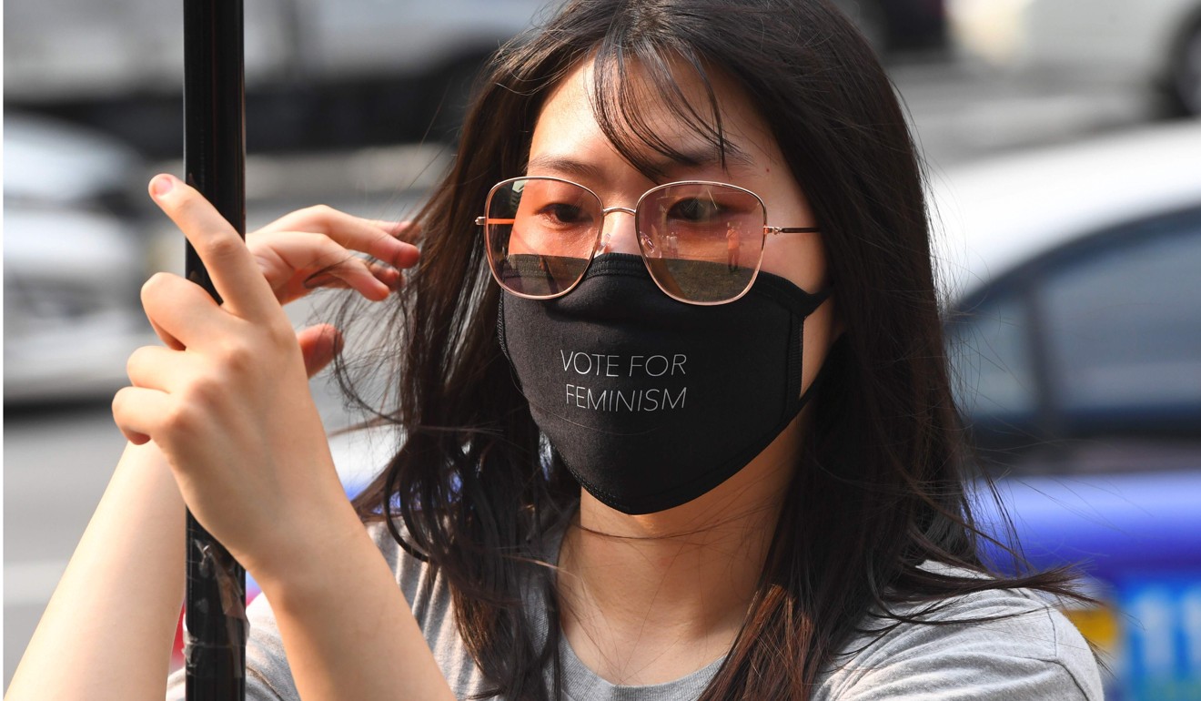 A woman wearing a black mask at the protest in Seoul. Photo: AFP