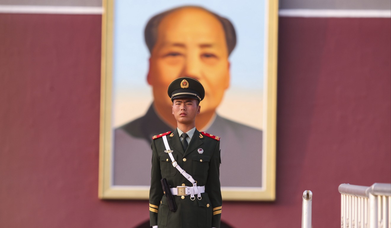 An armed policeman at the Tiananmen Rostrum, in front of a portrait of Mao Zedong. Mao Zedong Thought was, at least briefly, a living faith. Photo: Simon Song