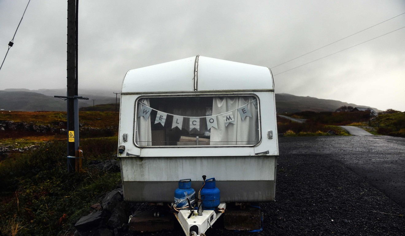 A caravan with a welcome sign strung across the window sits on the Isle of Ulva, off Scotland's west coast. Photo: AFP
