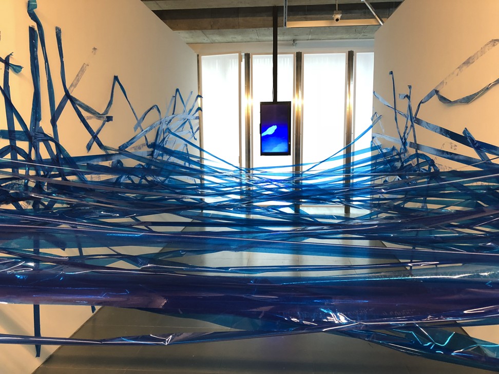 The entrance to the exhibition is obstructed by a sea of blue tape. Photo: Enid Tsui