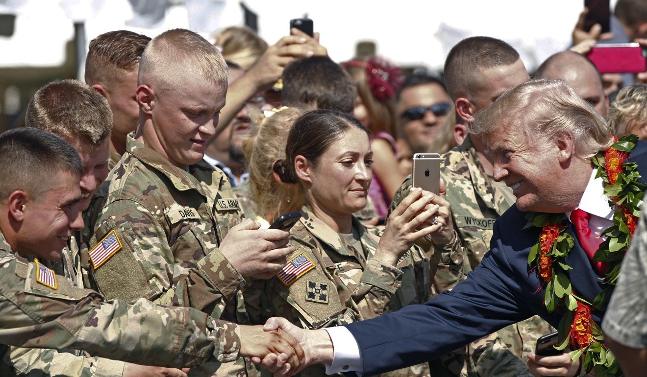 Trump greets servicemen after arriving at Joint Base Pearl Harbour Hickam in Honolulu. Photo: AP
