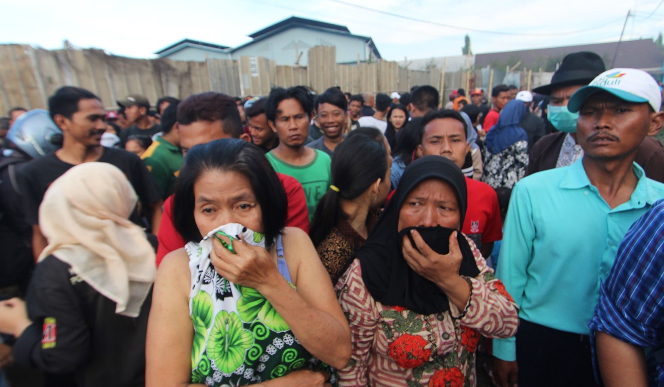 Indonesian gather at the fireworks factory that burned down. Photo: AFP