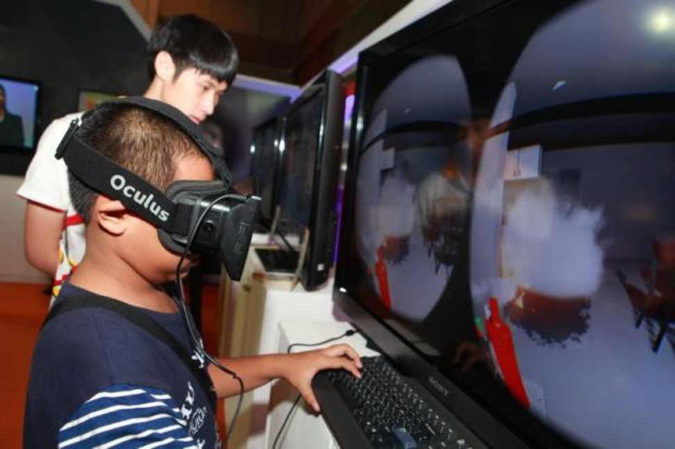 A little boy plays a virtual reality video game. Newly two-thirds of game makers say including in-game rewarded ads 'stabilised or increased' their user retention, according to a study. Photo: SOMCHAI POOMLARD/Bangkok Post