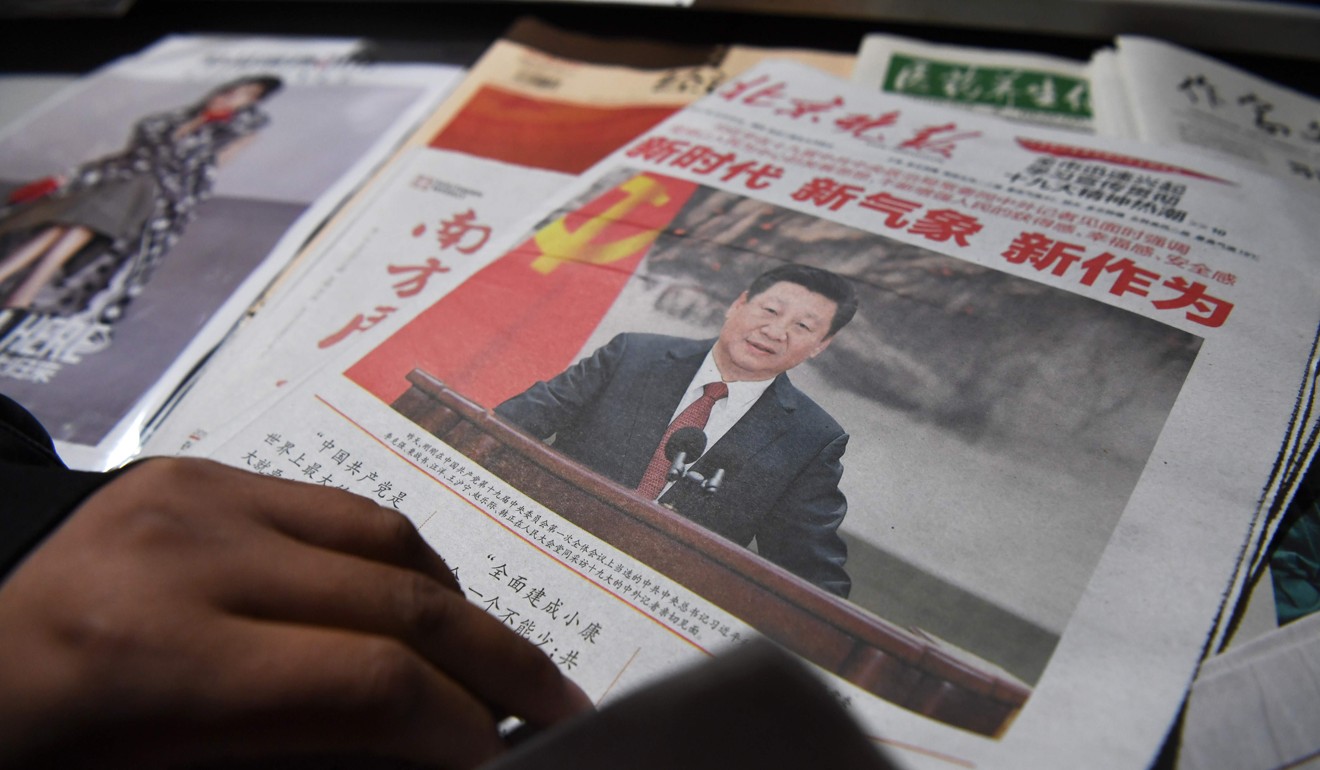Aa newspaper features President Xi Jinping a day after Xi introduced China's new Politburo Standing Committee in Beijing. Photo: AFP
