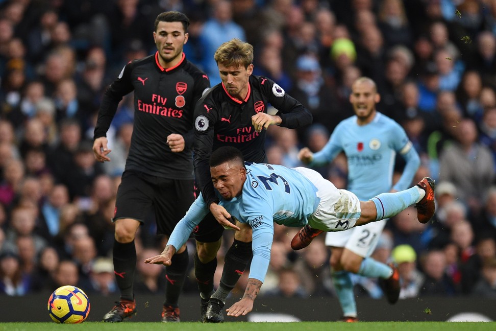 Manchester City’s Brazilian striker Gabriel Jesus vies for the ball with Arsenal’s Nacho Monreal. Photo: AFP