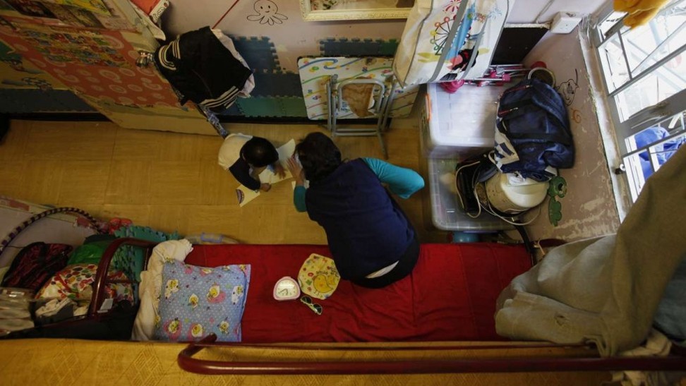 Play time for a child in a subdivided flat in Sham Shui Po. Photo: Reuters