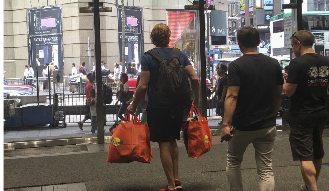 Members of Epic MMA Club leave the gym in Queen’s Road, Central, carrying their belongings after the chain went into liquidation. Photo: Kylie Knott